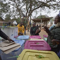 Electoral workers stand by ballot boxes stacked up at a collection center in Nairobi, Kenya Wednesday, Aug. 9, 2017. Kenyans went to the polls Tuesday in a general election after a tightly-fought presidential race between incumbent President Uhuru Kenyatta and main opposition leader Raila Odinga. (AP Photo/Ben Curtis)