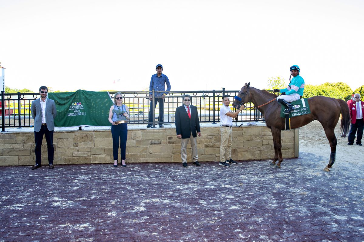Charlatan, with Jockey Martin Garcia onboard and trainer Bob Baffert in the winners circle after winning the The Arkansas Derby during the Covid-19 Pandemic on Derby Day at Oaklawn Racing Casino Resort on May 2, 2020 in Hot Springs, Arkansas.