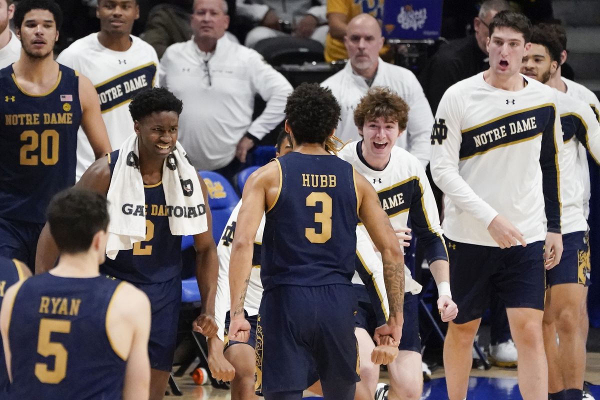 The Notre Dame bench reacts as Prentiss Hubb walks towards them after hitting a shot to give them the lead with less than 10 seconds left.