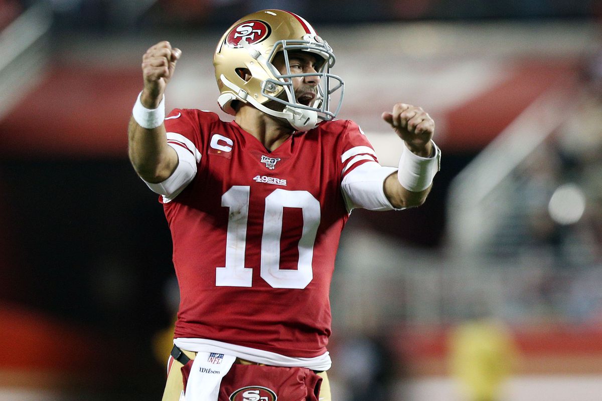 San Francisco 49ers quarterback Jimmy Garoppolo celebrates the touchdown scored by running back Raheem Mostert against the Green Bay Packers during the second half in the NFC Championship Game at Levi’s Stadium.
