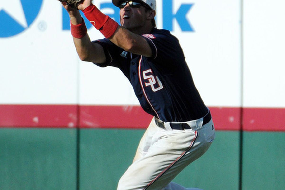 June 3, 2012; Tallahassee, FL, USA; Samford Bulldogs outfielder Brandon Miller (25) catches a ball for an out during the third inning in game six of the Tallahassee regional at Dick Howser Stadium.  Mandatory Credit: Melina Vastola-US PRESSWIRE