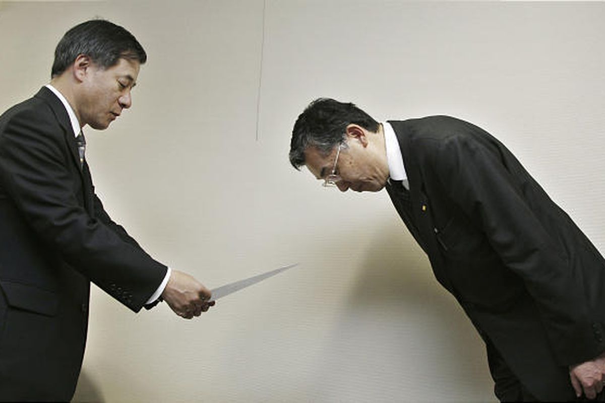 Toyota Motor Corp. Managing Officer Hiroyuki Yokoyama, right, bows after submitting the company's formal recall notice for its 2010 Prius gas-electric hybrid and two other hybrid models to Ryuji Masuno, director general of the Road Transport Bureau of the