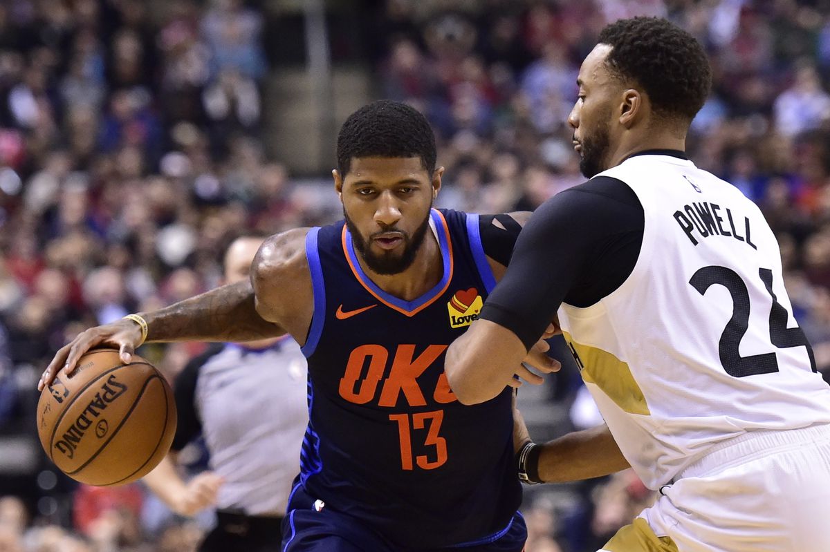 Oklahoma City Thunder forward Paul George (13) dribbles past Toronto Raptors forward Norman Powell (24) during second-half NBA basketball game action in Toronto, Friday, March 22, 2019.