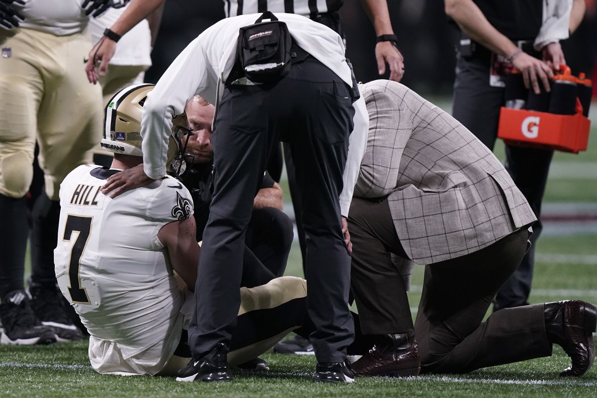 New Orleans Saints quarterback Taysom Hill (7) is helped after injury against the Atlanta Falcons.