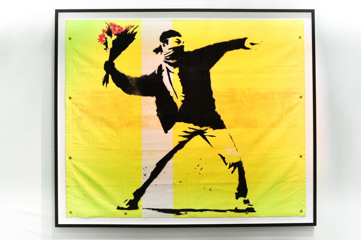 Banksy, “Flower Thrower,” is among the artist’s works featured in “The Art of Banksy.”