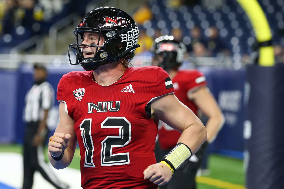 Northern Illinois Huskies quarterback Rocky Lombardi (12) smiles as he runs to the sideline after scoring a touchdown during the Mid-American Conference football championship game between the Kent State Golden Flashes and the Northern Illinois Huskies on December 4, 2021 at Ford Field in Detroit, Michigan.