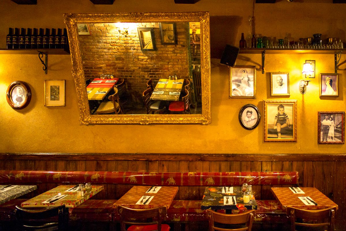 The wall of an East Village Italian restaurant, Lil’ Frankies, is decorated with mirrors and childhood photos.