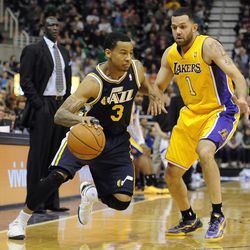 Utah Jazz point guard Trey Burke (3) drives past Los Angeles Lakers point guard Jordan Farmar (1) during a game at EnergySolutions Arena on Friday, Dec. 27, 2013.