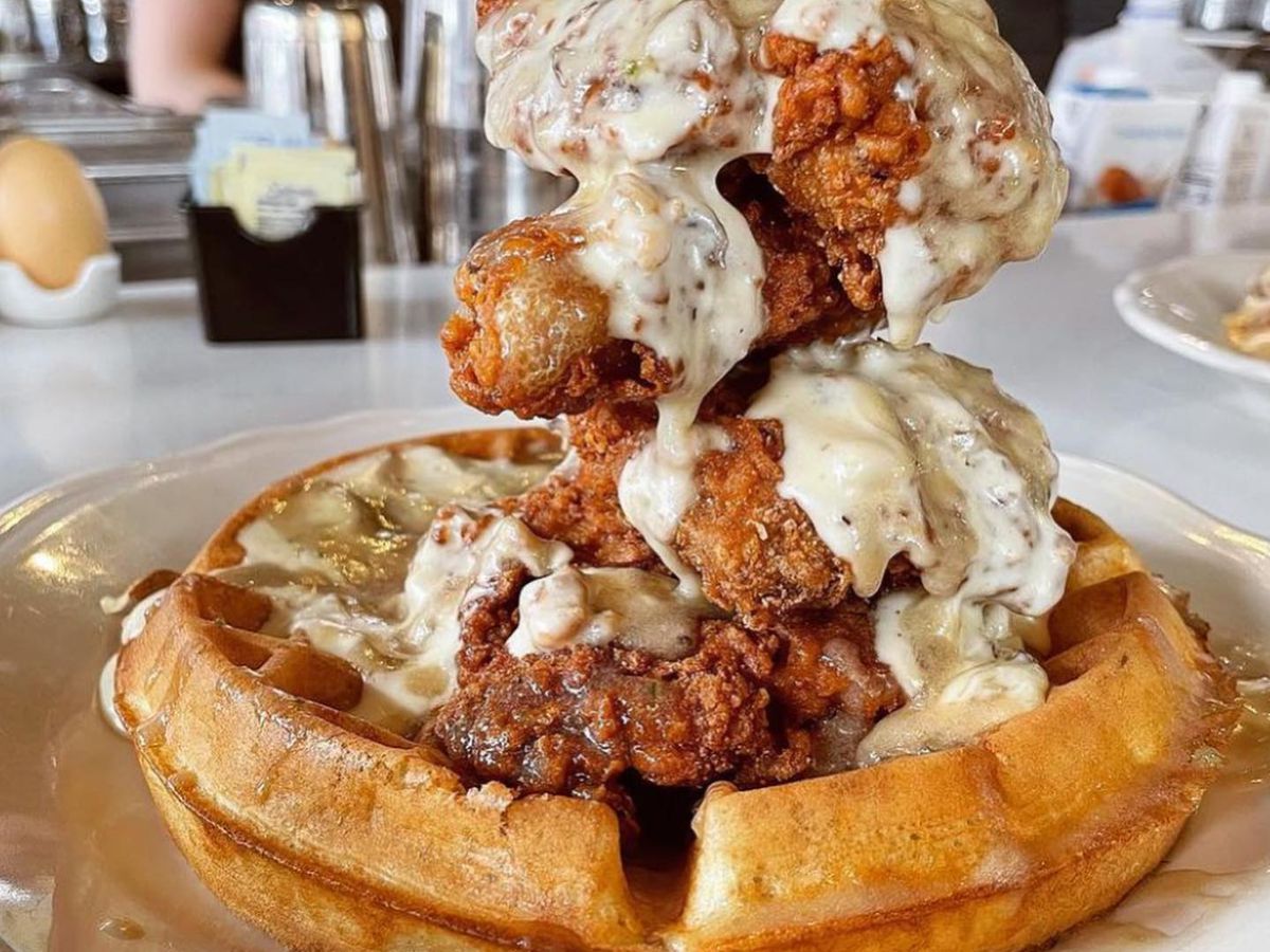 A thick golden waffle topped with fried chicken and gravy.