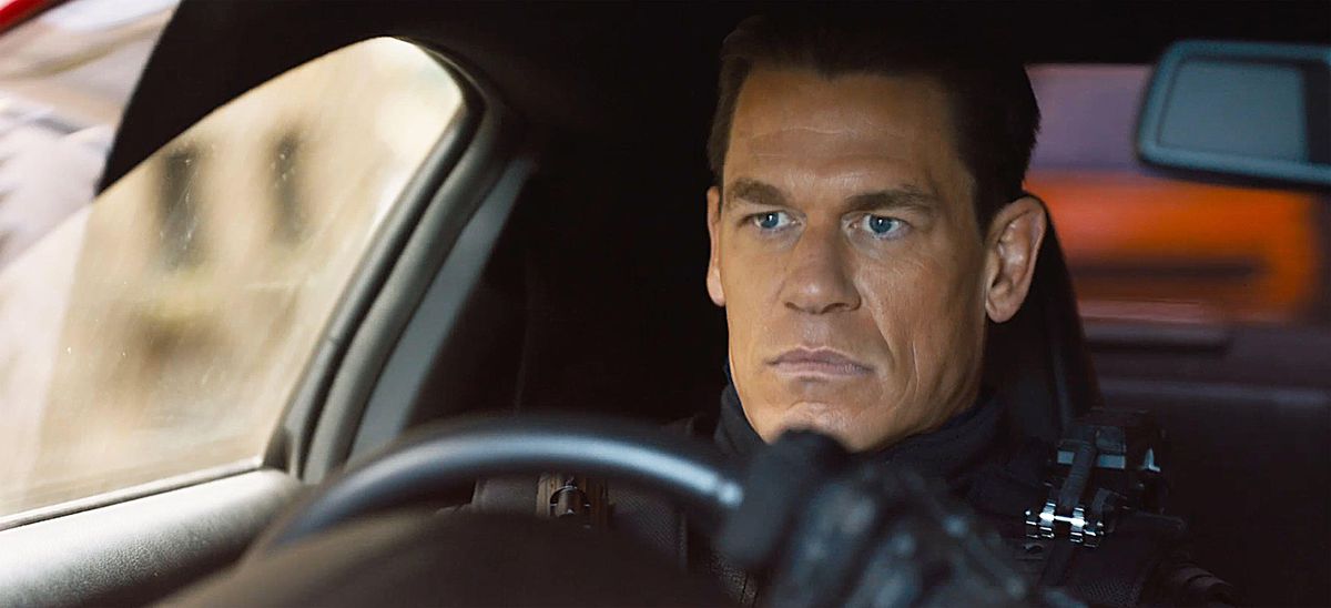 Jakob (John Cena, in a whoooole lot of surprisingly orange bronzer that he doesn’t wear in the last film) sits broodingly in a car in F9