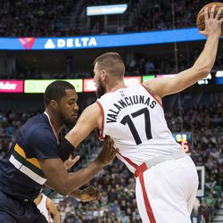 Toronto center Jonas Valanciunas (17) holds the ball away from Utah forward Derrick Favors (15) during an NBA basketball game in Salt Lake City on Friday, Dec. 23, 2016. Toronto took down Utah with a final score of 104-98.