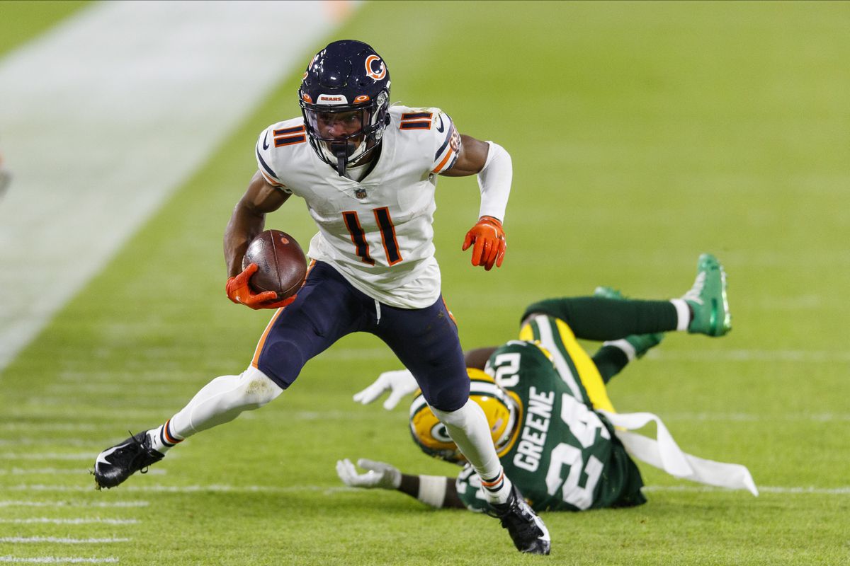 Chicago Bears wide receiver Darnell Mooney (11) rushes with the football in front of Green Bay Packers free safety Raven Greene (24) after catching a pass during the second quarter at Lambeau Field.