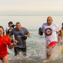 Boxers Luis Mateo (center left) and Fres Oquendo (center right) take the Polar Bear Plunge on Saturday. | Tyler LaRiviere/Sun-Times