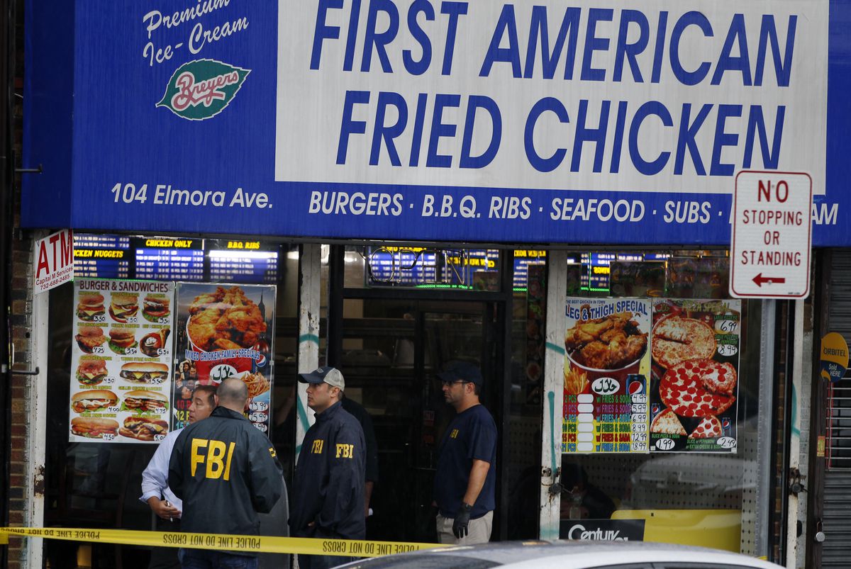 FBI agents search the Rahami family’s storefront chicken takeout restaurant and the apartment that is tied to Ahmad Khan Rahami on Monday, Sept. 19, 2016, in Elizabeth, New Jersey. | Mel Evans/AP