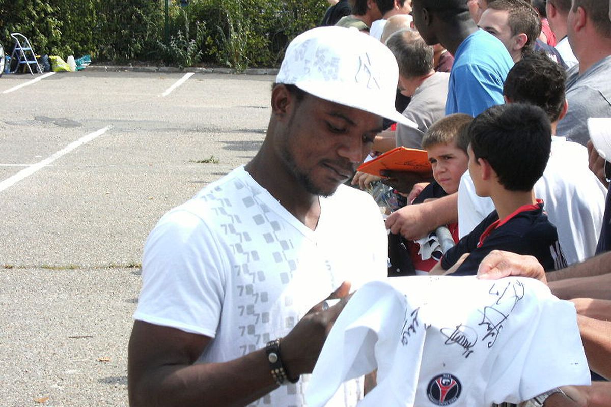 Is that Robinson Cano? Oh, wait, it Stephane Sessegnon, signing autographs for fans more concerned with staring at the surrounding shrubbery than meeting the PSG midfielder. 

(via Wikimedia Commons, by psgmag.net)