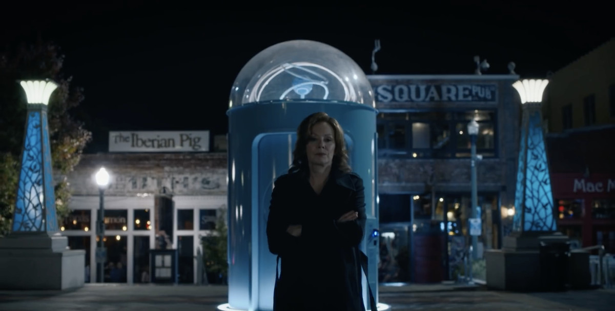Blake turns her back on a monument to Dr. Manhattan featuring the hydrogen symbol he took as his own.