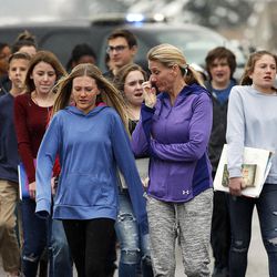 April Williams, center, walks with daughter Avery, as students are released from Mueller Park Junior High School in Bountiful on Thursday, Dec. 1, 2016, following a shooting at the school.