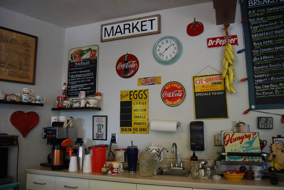 Inside Mary’s Market in Sierra Madre with white walls covered in vintage signage gifted by regulars.