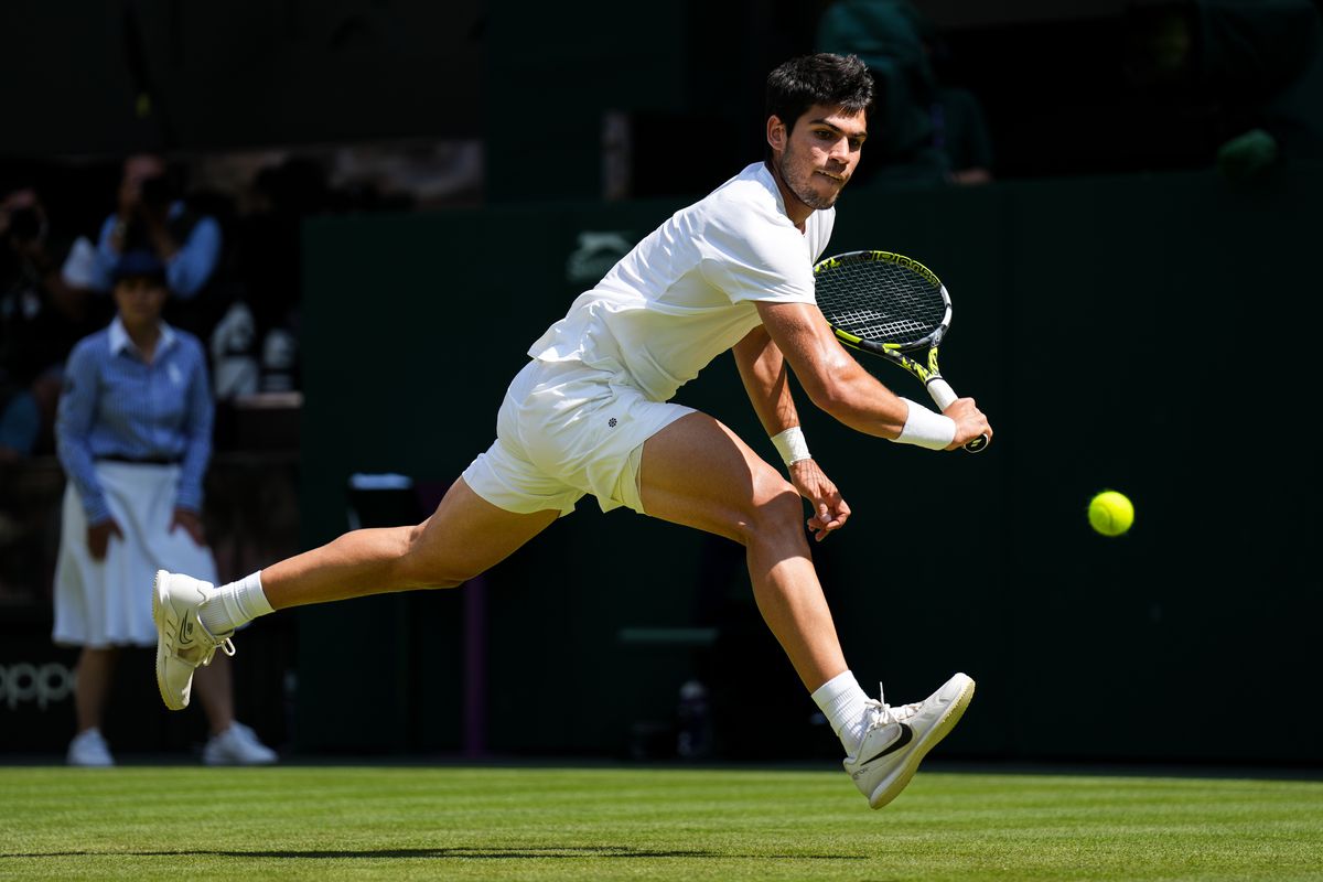 Carlos Alcaraz of Spain plays a backhand in the Men’s Singles second round match against Alexandre Muller of France during day five of The Championships Wimbledon 2023 at All England Lawn Tennis and Croquet Club on July 07, 2023 in London, England.