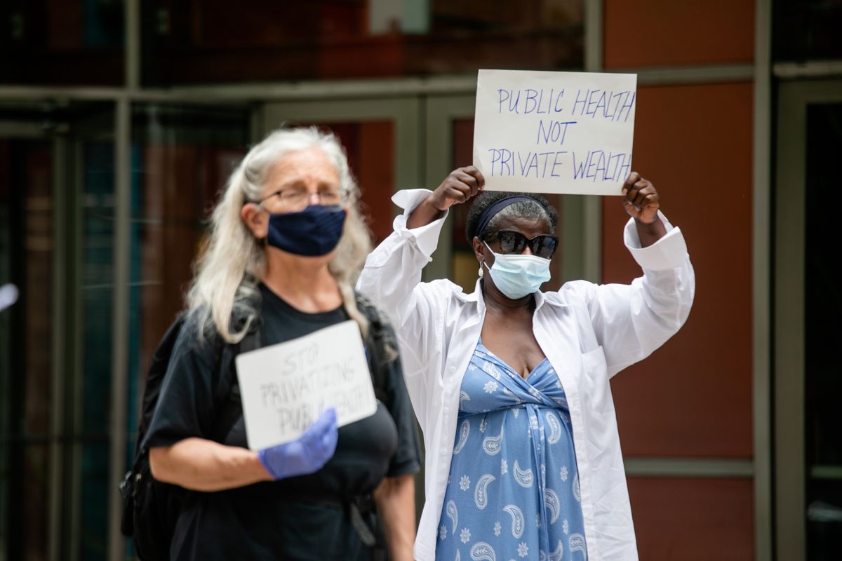 Local officials, community organizers and residents attend a press conference outside the James R. Thompson Center on June 30, 2020. They called on Gov. J.B. Pritzker to stop Chicago Department of Public Health from outsourcing COVID-19 contact tracers and testers to private entities.