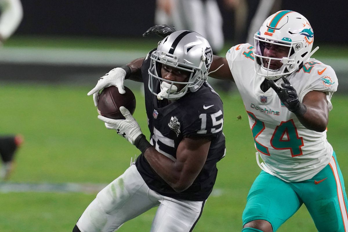 Las Vegas Raiders wide receiver Nelson Agholor (15) is defended by Miami Dolphins cornerback Byron Jones (24) on an 85-yard touchdown reception in the fourth quarter at Allegiant Stadium. The Dolphins defeated the Raiders 26-25.