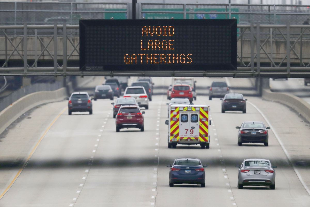 A sign over the Dan Ryan Expressway warns against large gatherings during the coronavirus pandemic. Social distancing is especially important for African Americans who are at greater risk of COVID-19.