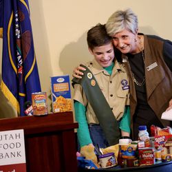 Ginette Bott, chief development officer for the Utah Food Bank, hugs Boy Scout Ryan Buhler of Taylorsville's Troop 366 during the kickoff of the 30th annual Scouting for Food event at the Capitol in Salt Lake City on Thursday, March 17, 2016.  