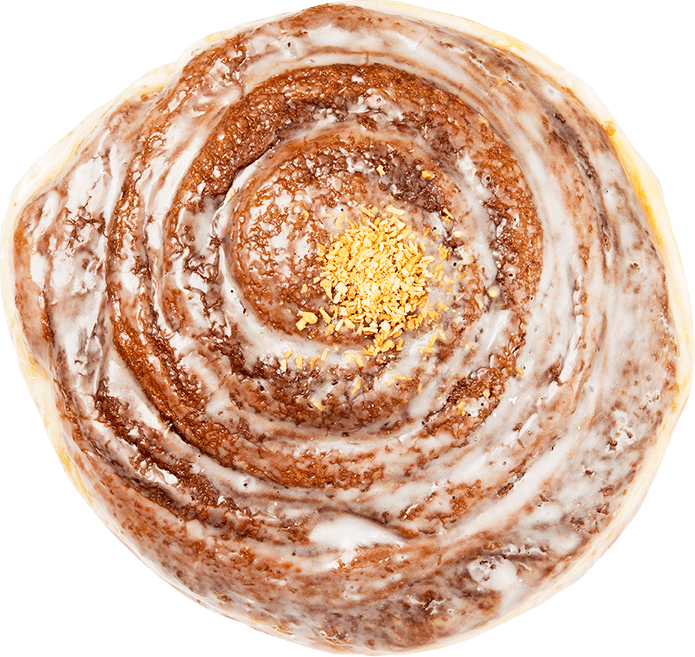 Closeup overhead shot of a swirled coffee roll with a white glaze