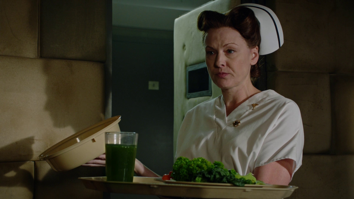 nurse ratched holding a plate of very bland and unseasoned vegetables