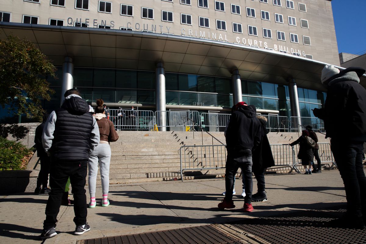 People wait to enter Queens Criminal Court while COVID restrictions were in place, Nov. 8, 2021.