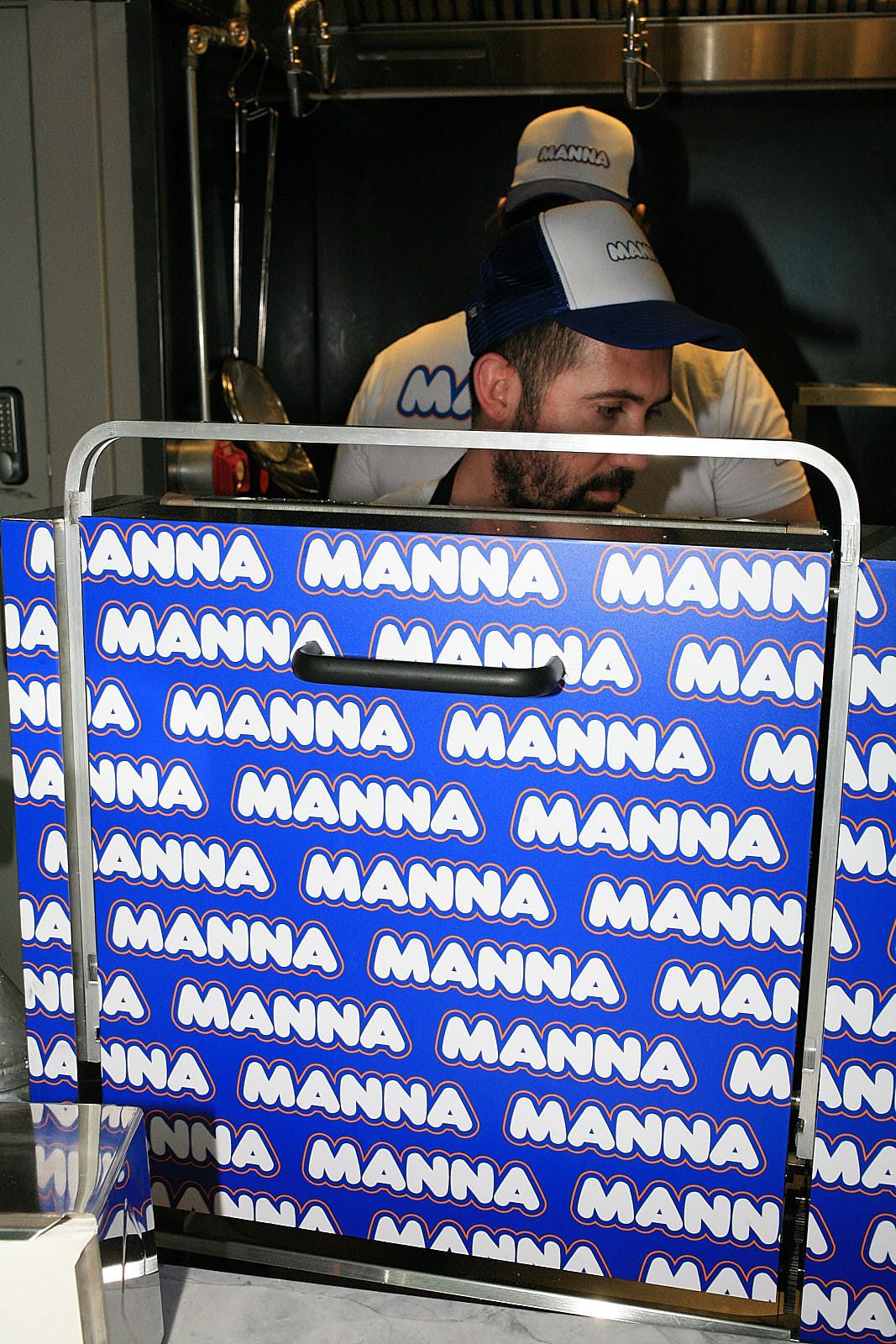 Blue and white branding for Manna at Arcade Food Hall