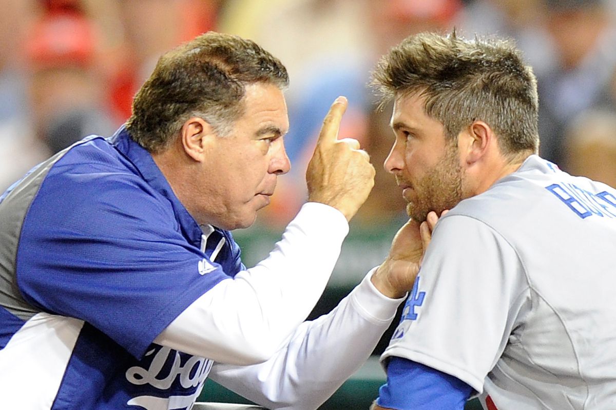 Director of medical services Stan Conte checks on Drew Butera of the Los Angeles Dodgers after Butera was hit in the face by a foul ball