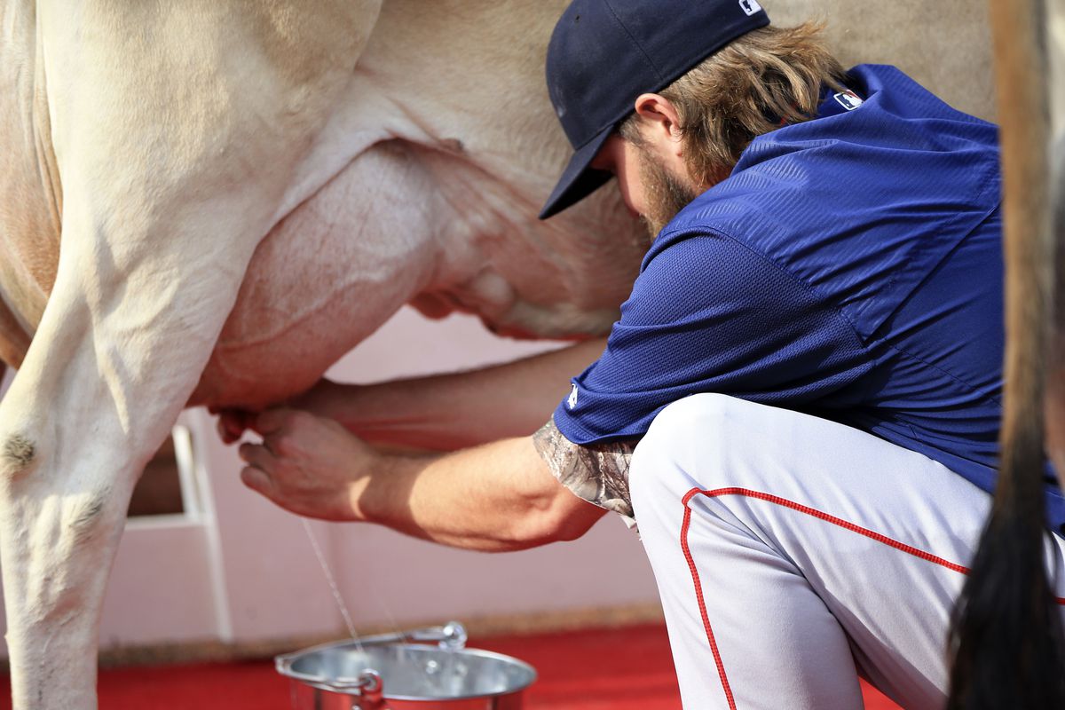 Here is a picture of Wade milking a cow at Globe Life Park. Because why not?