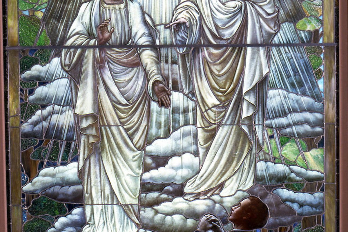 "Joseph Smith's First Vision" in a stain glass window.