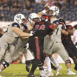 San Diego State’s Andrew Aleki pushes toward Utah State quarterback Jordan Love as Love throws a pass during an NCAA college football game Saturday, Sept. 21, 2019, in San Diego. (Hayne Palmour IV/The San Diego Union-Tribune via AP)