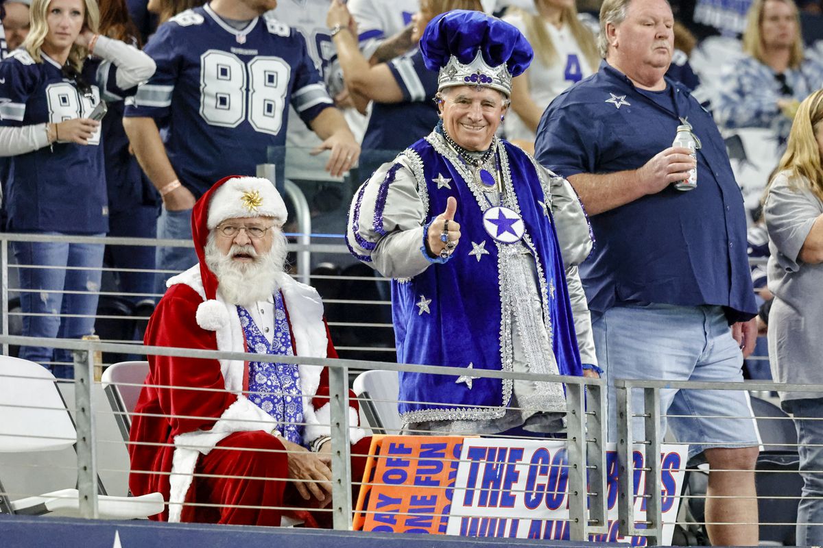 Dallas Cowboys fans cheer during the game between the Dallas Cowboys and the Washington Football Team on December 26, 2021 at AT&amp;T Stadium in Arlington, Texas.
