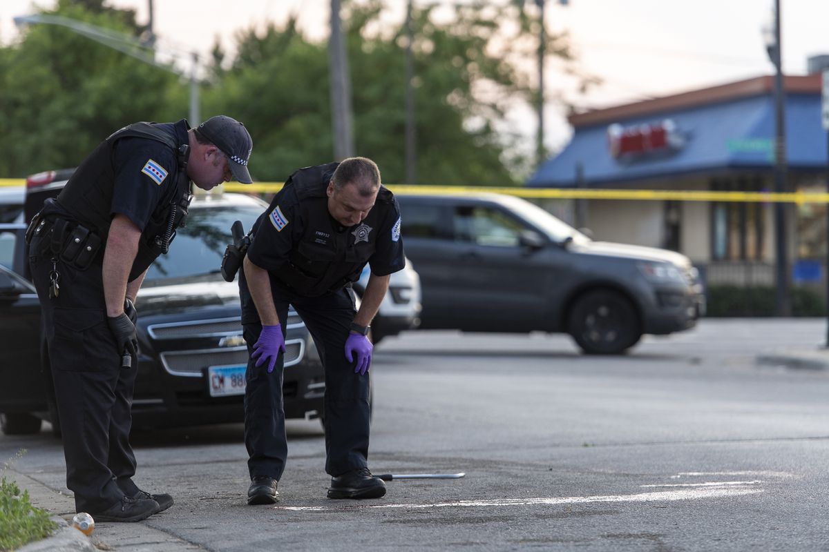Chicago police work a crime scene where a man was shot in the head and his vehicle stolen in the 6400 block of South Cicero Ave, Monday May 24, 2021. The man was helping change a friends flat tire when he was shot. | Tyler LaRiviere/Sun-Times