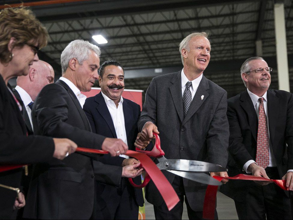 Mayor Rahm Emanuel and Gov. Bruce Rauner join Shahid Khan (center), owner of auto parts manufacturer Flex-N-Gate, for a ribbon-cutting ceremony, as the company is opening a new factory at 2924 E. 126th St., last year. File Photo. | Ashlee Rezin/Sun-Times