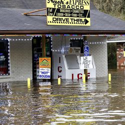 Flood waters rise against Nash's Express convenience store in Hammond, La., Friday, March 11, 2016. Torrential rains pounded northern Louisiana for fourth day Friday, trapping several hundred people in their homes, leaving scores of roads impassable and causing widespread flooding.