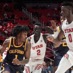 California guard Joel Brown (1) looks to go past Utah guard Both Gach (2) and Utah center Lahat Thioune during an NCAA game at the Huntsman Center in Salt Lake City on Sunday, Dec. 5, 2021.
