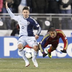 Real's Chris Schuler dives dives to the turf as he tries to get around Kansas City's Claudio Bieler as Real Salt Lake and Sporting KC play Saturday, Dec. 7, 2013 in MLS Cup action. Sporting KC won in a shootout.