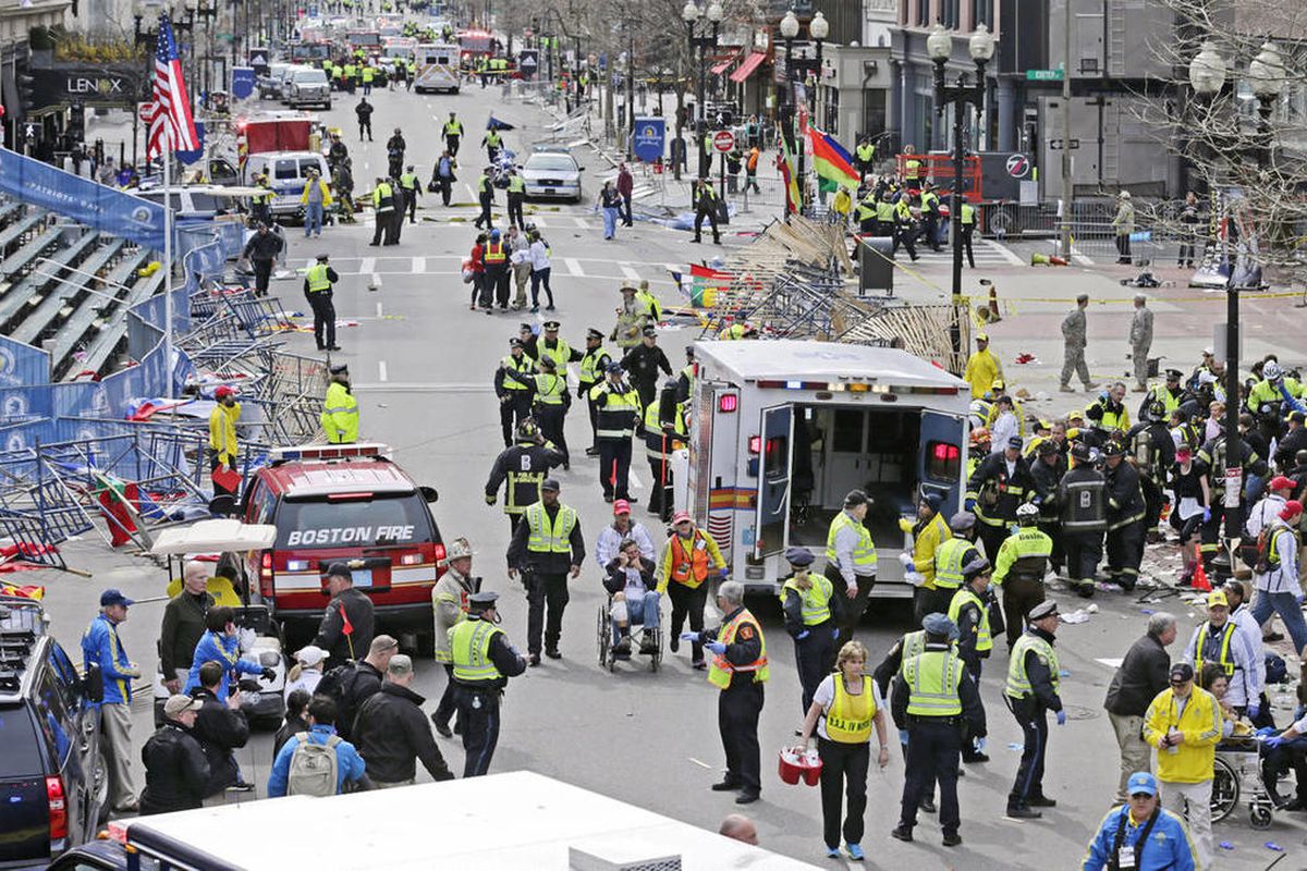 Medical workers aid injured people at the finish line of the 2013 Boston Marathon following explosions in Boston, Monday, April 15, 2013. Two explosions shattered the euphoria of the Boston Marathon finish line on Monday, sending authorities out on the co