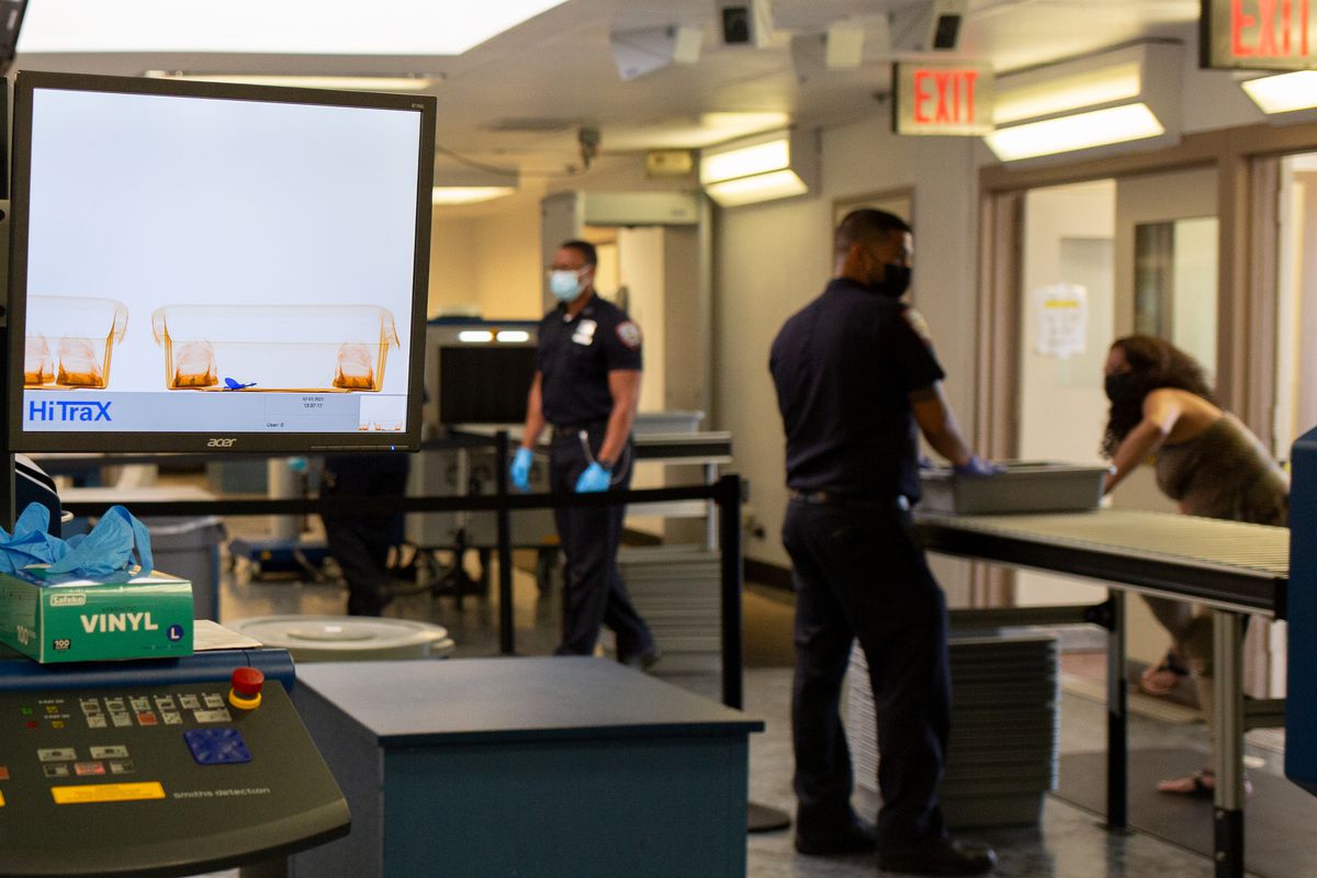 Department of Correction officers screen visitors on Rikers Island, July 1, 2021.