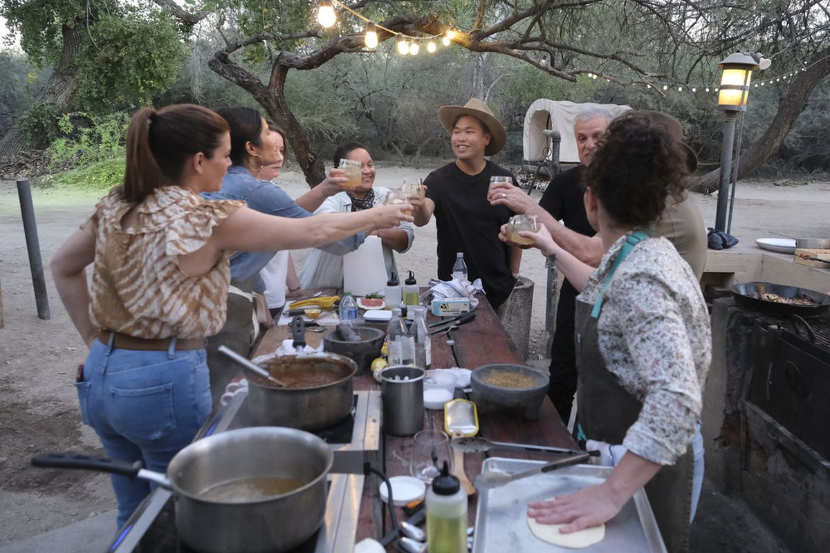 “Top Chef: Houston” judges and finalists cheers drinks in the desert.
