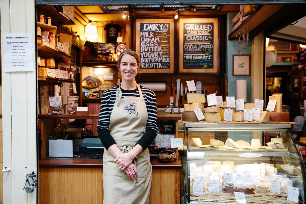 Anne Saxelby stands in front of Saxelby Cheesemongers, her New York City cheese shop