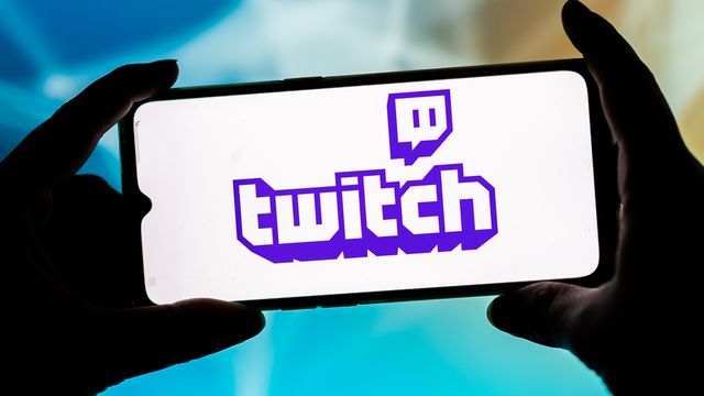 a photo illustration of the Twitch logo on a smartphone