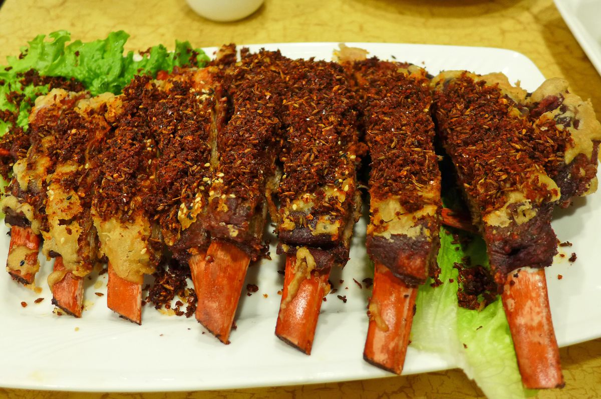 Big ribs with red bones heaped with spices.