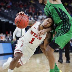 Utah Utes guard Justin Bibbins drives with Oregon Ducks forward Troy Brown defending during the Pac-12 basketball tournament in Las Vegas on Thursday, March 8, 2018.