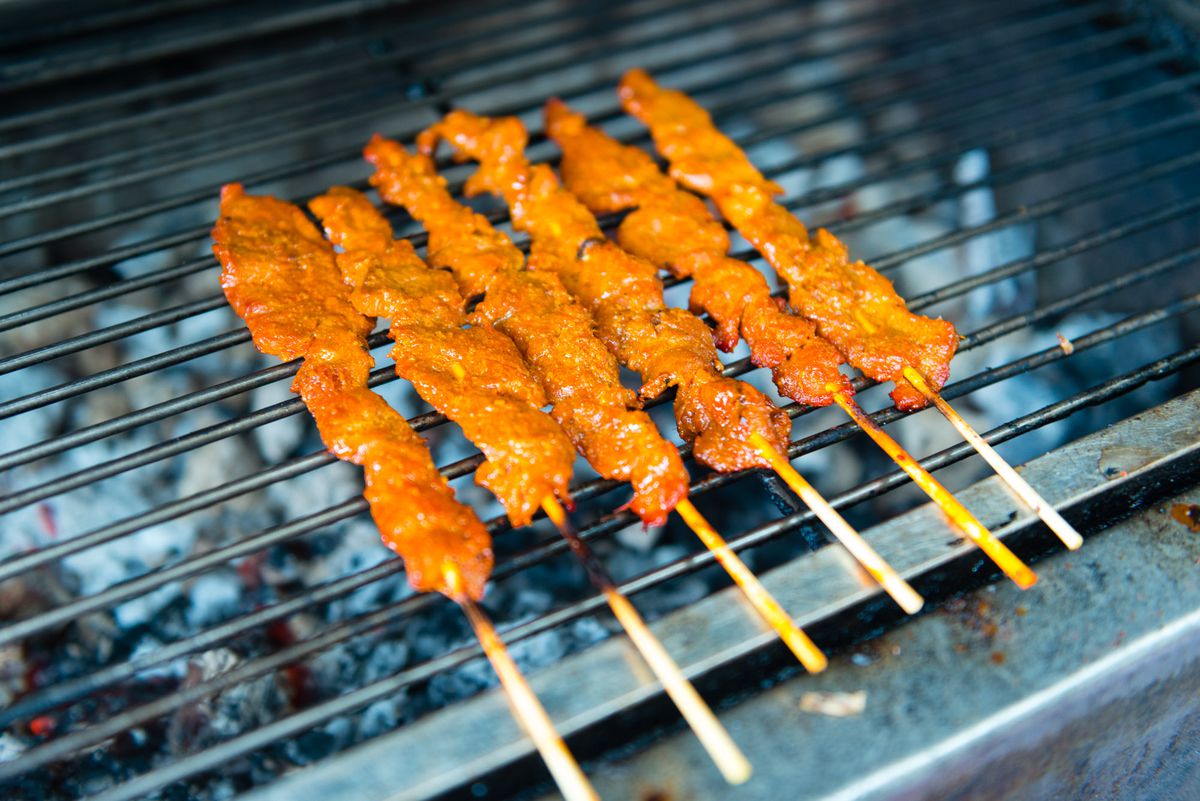 Skewers of glazed meat on the grill.