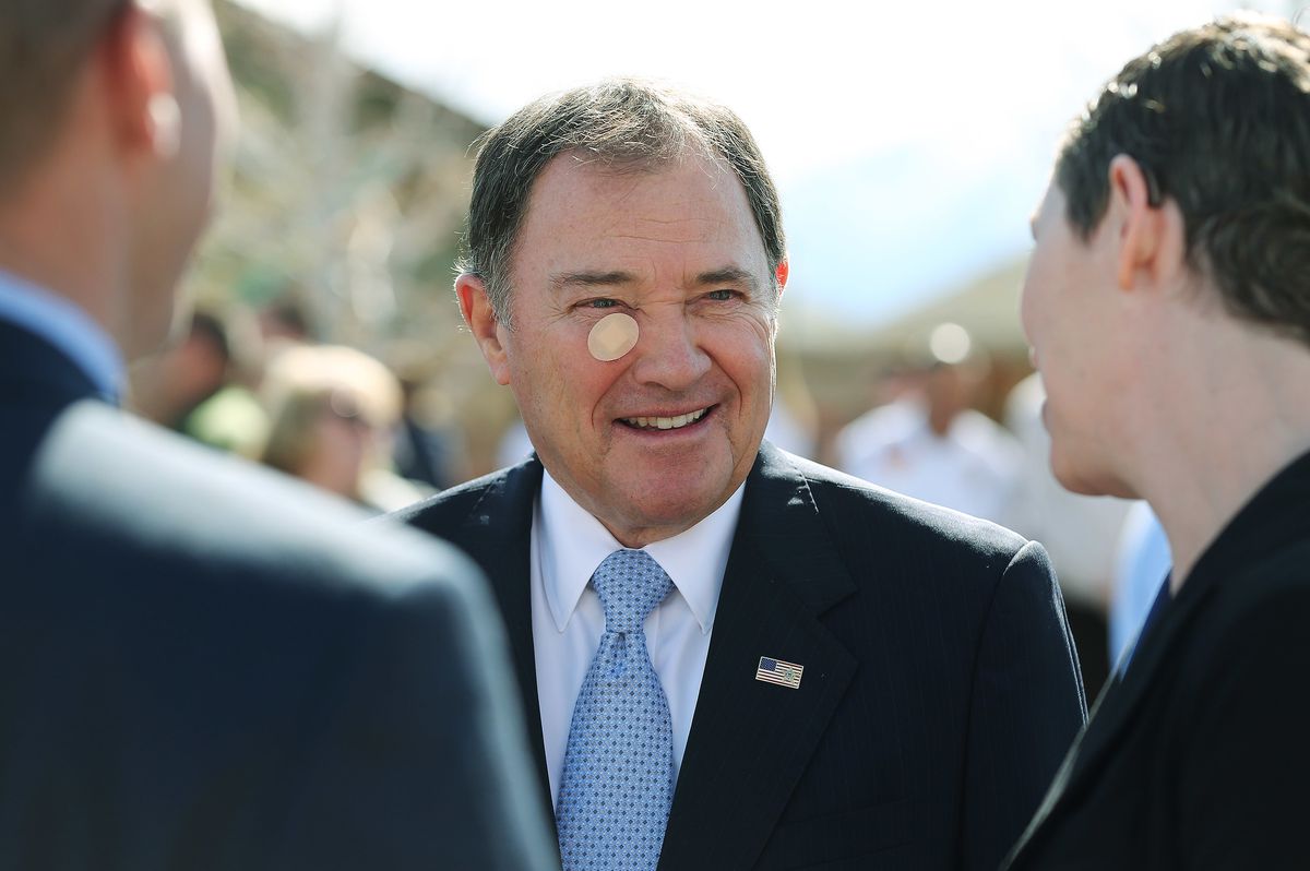 Gov. Gary Herbert, sporting a bandage on his cheek after surgery for skin cancer, talks with attendees before a ceremonial bill signing and groundbreaking for a school in West Jordan on Wednesday, April 24, 2019.